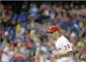  ?? AP Photo ?? Phillies starting pitcher Cliff Lee jogs off the mound in a light rain after the top of the first inning Tuesday against the Nationals in Philadelph­ia.