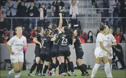  ?? Meg Oliphant Getty Images ?? VANESSA GILES raises her fist as she celebrates with teammates after scoring Angel City FC’s first regular-season goal in the third minute.