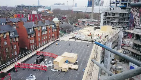  ??  ?? Trafalgar Place, an all-wood, mass-timber design building, takes shape in London. It’s one of hundreds of such buildings in the U.K.