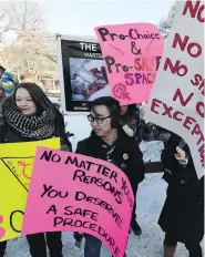  ?? JOHN LUCAS / POSTMEDIA NEWS FILES ?? Pro-choice counter-protesters stand in front of graphic abortion photos at the University of Alberta in May 2015.