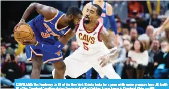  ??  ?? CLEVELAND: Tim Hardaway Jr #3 of the New York Knicks looks for a pass while under pressure from JR Smith #5 of the Cleveland Cavaliers during the second half at Quicken Loans Arena in Cleveland, Ohio. — AFP