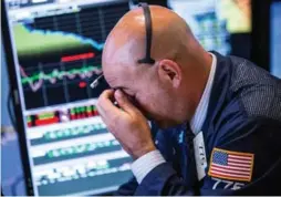  ?? ANDREW BURTON/GETTY IMAGES ?? Markets in the U.S. and Europe plunged to seven-month lows Thursday.