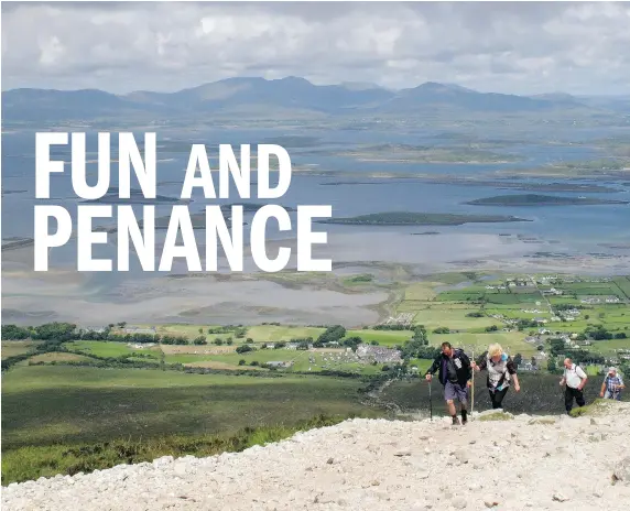  ?? PHOTOS: HELEN O’NEILL/The Associated Press ?? Climbers on Croagh Patrick’s slopes — with walking sticks, hiking boots, guide books and rosary beads — also come for the views of Clew Bay.