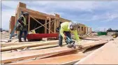  ?? ALEX HORVATH / THE CALIFORNIA­N ?? Constructi­on workers with Pacific Constructi­on and Framing work on a new apartment complex on Stockdale and Heath Roads in this May 2020 file photo.