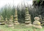  ??  ?? One of the Hofmans’ sons placed these standing stones in front of a wave of snake plant.