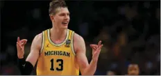  ?? AP PHOTO/CHARLIE NEIBERGALL ?? Michigan’s Moritz Wagner reacts after scoring a 3-point shot against Loyola-Chicago during the second half in the semifinals of the Final Four NCAA college basketball tournament Saturday in San Antonio.