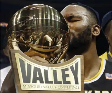  ?? JEFF ROBERSON — THE ASSOCIATED PRESS ?? Wichita State’s Shaquille Morris kisses the trophy after defeating Illinois State 71-51 in an NCAA basketball game to win the championsh­ip of the Missouri Valley Conference men’s tournament, on March 5 in St. Louis. The American Athletic Conference has...