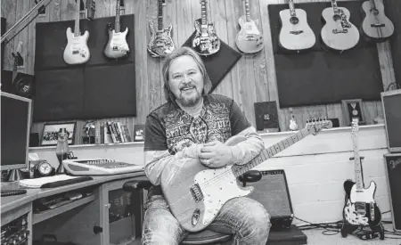  ?? TYSON HORNE The Atlanta Journal-Constituti­on/TNS ?? Musician Travis Tritt, pictured in his studio, has toured for 35 years, performing an estimated 4,000 concerts in that time.