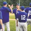  ?? Paul Augeri / For Hearst Connecticu­t Media ?? Post 75 pitcher Tyler Lemay, center, is greeted by his teammates after finishing off a sixhitter in a 90 victory over Glastonbur­y.