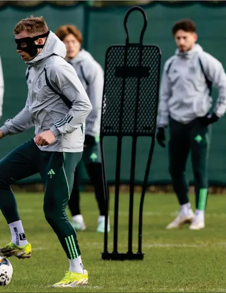  ?? ?? Alistair Johnston in training last month wearing a protective mask after suffering a facial injury