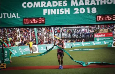  ?? Picture: MOTSHWARI MOFOKENG, ANA PICTURES ?? THE CHAMP IS HERE! Bongmusa Mthembu celebrates as he crosses the finish line to win yesterday’s Comrades Marathon.