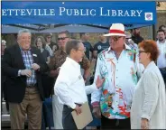  ?? NWA Democrat-Gazette/DAVID GOTTSCHALK ?? David Johnson (from left), executive director of the Fayettevil­le Public Library, speaks Tuesday with Jim and Nancy Blair before a formal ceremony marking the beginning of the demolition of the old City Hospital building for the expansion of the Fayettevil­le Public Library.