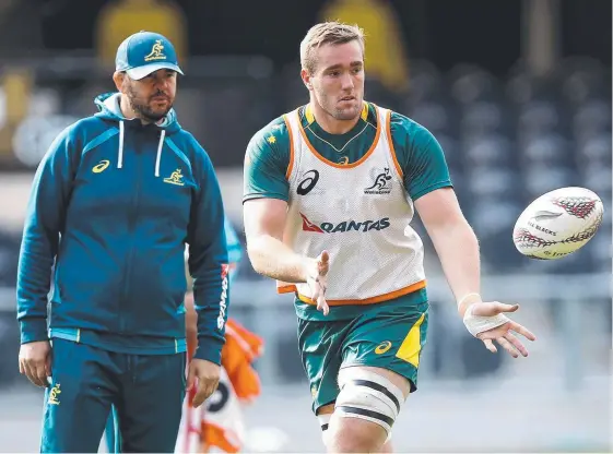  ?? Picture: GETTY IMAGES ?? Izack Rodda in action during Wallabies training at Forsyth Barr Stadium in Dunedin as coach Michael Cheika looks on,