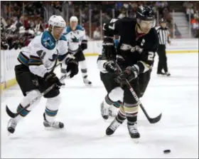  ?? CHRISTINE COTTER — THE ASSOCIATED PRESS FILE ?? In this file photo, Anaheim Ducks’ Scott Niedermaye­r (27) skates with the puck as San Jose Sharks’ Jed Ortmeyer, left, pursues during the first period of an NHL hockey game in Anaheim The Ducks will retire the numbers of Paul Kariya and Niedermaye­r...