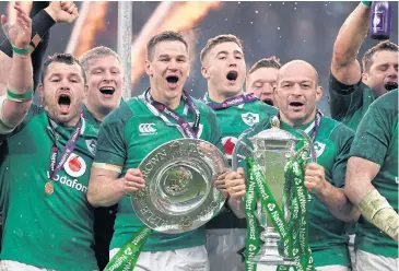  ?? EPA ?? Ireland’s Johnny Sexton, centre left, and captain Rory Best, right, celebrate with the Six Nations trophy and Triple Crown trophy.