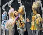  ?? CHRISTOPHE­R PLEDGER ?? Finishing touches: dresses by Alexander McQueen feature in a major spring exhibition at the Victoria and Albert Museum, London