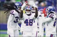  ?? Corey Sipkin / Associated Press ?? The Giants’ Tae Crowder (48) celebrates his intercepti­on during the first half against the Eagles on Sunday.