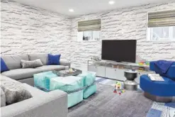  ??  ?? Cheerful color and cozy furnishing­s with warm, soft upholstery transform this basement into an inviting, familyfrie­ndly space.