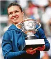  ?? Cameron Spencer / Getty Images ?? Halep becomes the first Romanian to win a major title since Virginia Ruzici in 1978.