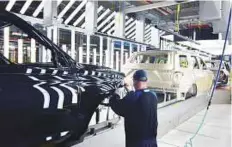  ?? Reuters ?? A Ford worker with a Ford Expedition SUV at Ford’s Kentucky Truck Plant as the automaker ramps up production of two large SUV models in Louisville, Kentucky, US.