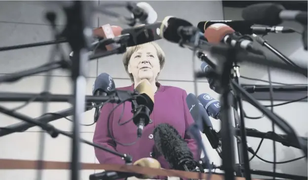  ?? PICTURE: AP ?? 0 German Chancellor Angela Merkel delivers a statement in Berlin, as she entered talks with the Social Democrats on forming a new government