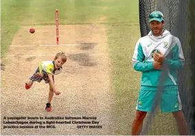  ?? GETTY IMAGES ?? A youngster bowls to Australian batsman Marnus Labuschagn­e during a light-hearted Christmas Day practice session at the MCG.