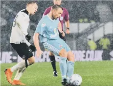  ??  ?? Lee Cattermole plays a pass in the rain at Derby on Friday.