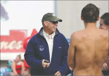  ?? BEA AHBECK/NEWS-SENTINEL ?? Lodi coach John Griffin speaks with swimmers during the swim meet at Lodi High on Friday. Griffin had a heart attack just before the start of the season last year, and had a pacemaker put in last month.