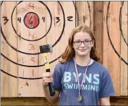  ?? PHOTO BY JESI YOST — FOR MEDIANEWS GROUP ?? Simone Mitchell, 14, of Boyertown competed against her father at the ThrowHouse Ax throwing booth, winning a medal at Boyertown’s Oktoberfes­t.