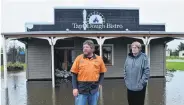  ?? PHOTO PETER MCINTOSH ?? Devastated . . . Owners Richard and Norma Emerson outside their flooded business at Middlemarc­h in November.