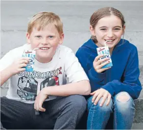  ?? Photo: KEVIN STENT/FAIRFAX NZ ?? New style: Lyall Bay School milk ambassador­s Sam Murphy, 9, and Gwyneth Martin-Greig,10, get an early taste of the milk they will distribute.