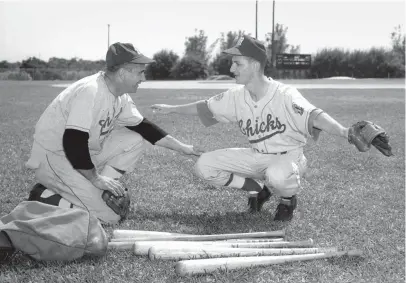  ?? THE COMMERCIAL APPEAL ?? Luke Appling, left, new manager of the Memphis Chicks, tests the right knee of shortstop Mel Rue as spring training opens in Fort Pierce, Florida, for the Memphis club on March 7, 1951.