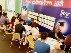  ??  ?? Pulling in the crowd: Visitors busy discussing options at the Star Education Fund booth during the Star Education Fair 2018 in Spice Arena, Penang.