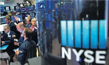  ?? EDUARDO MUNOZ/REUTERS ?? Traders work on the floor at the New York Stock Exchange (NYSE) in New York, last month.