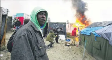  ?? Picture: Adam Gray/SWNS.com ?? Tents burn at the Jungle during the dismantlin­g of the Calais migrant camp