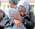  ??  ?? TRAGIC: Nazeema Abrahams comforts one of children left orphaned after their parents were killed in a fire.