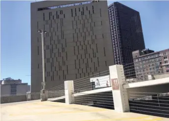  ??  ?? This is where Briana Fitzgibbon­s saw nude dancing and sex acts take place — on the top floor of a self- park garage across from the Metropolit­an Correction­al Center.
| RICH HEIN/ SUN- TIMES