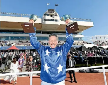  ?? GETTY IMAGES ?? Natalie Rasmussen poses with the trophies for best trainer and best driver after her triumph on Thefixer in the New Zealand Cup in Christchur­ch.