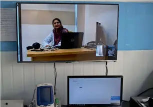  ?? AFP ?? doctor nadia speaks via skype at a telemedici­ne online treatment centre in behali area. —