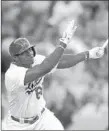  ?? MARK J. TERRILL/ THE ASSOCIATED PRESS ?? Yasiel Puig of the Dodgers follows through while hitting a solo homer in the first inning of a 3-1 victory over the San Francisco Giants on Monday night at Los Angeles.