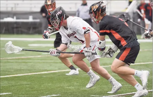  ?? Dave Stewart / Hearst Connecticu­t Media ?? New Canaan’s Braden Sweeney (91) scoops up a loose ball in front of Ridgefield’s Ryan Colsey at Dunning Field in New Canaan on Saturday.