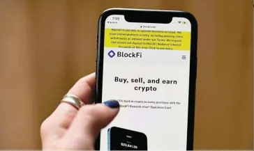  ?? — Bloomberg ?? Crypto collapse: The Blockfi website on a smartphone of a user in Brooklyn, New York. The cryptocurr­ency lender says it has around Us$257mil (Rm1.2bil) of cash on hand and is starting an internal plan to considerab­ly reduce expenses.