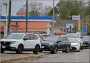  ?? STUART CAHILL / HERALD STAFF ?? Cars line up on Route 3A in Hingham to fill up with gas on Thursday.