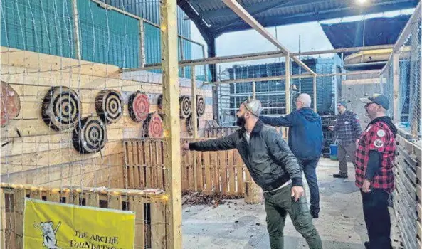  ?? ?? EVOKING THE VIKING SPIRIT: Members of the Viking Surgeons Associatio­n unwind with some axe throwing at Ace Targets Skye.