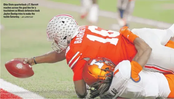  ??  ?? Ohio State quarterbac­k J. T. Barrett reaches across the goal line for a touchdown as Illinois defensive back Jaylen Dunlap tries to make the tackle Saturday.
| JAY LAPRETE/ AP