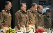  ?? — BIPLAB BANERJEE ?? Delhi police commission­er Amulya Patnaik ( 2nd from left) and other top city police officers stand in silence to honour those policemen who died on duty during a press conference in New Delhi on Thursday.