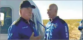  ?? Blue Origin ?? WILLIAM SHATNER, left, talks with Jeff Bezos about his experience after exiting the Blue Origin capsule near Van Horn, Texas, on Wednesday.