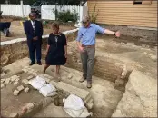  ?? BEN FINLEY — THE ASSOCIATED PRESS ?? Reginald F. Davis, from left, pastor of First Baptist Church in Williamsbu­rg, Connie Matthews Harshaw, a member of First Baptist, and Jack Gary, Colonial Williamsbu­rg’s director of archaeolog­y, stand at the brick-and-mortar foundation of one the oldest Black churches in the U.S. in Williamsbu­rg, Va., on Wednesday.