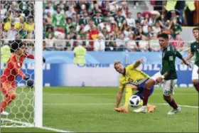  ?? MARTIN MEISSNER — THE ASSOCIATED PRESS ?? Mexico’s Edson Alvarez, right, scores an own goal to give Sweden a 3-0 lead.