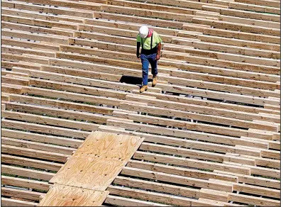  ?? AP ?? A workman walks along a structure being built for the NFL Draft in Nashville, Tenn., last month. Constructi­on payrolls added 49,000 jobs in April although constructi­on spending fell 0.9% the previous month, the Commerce Department said Wednesday.